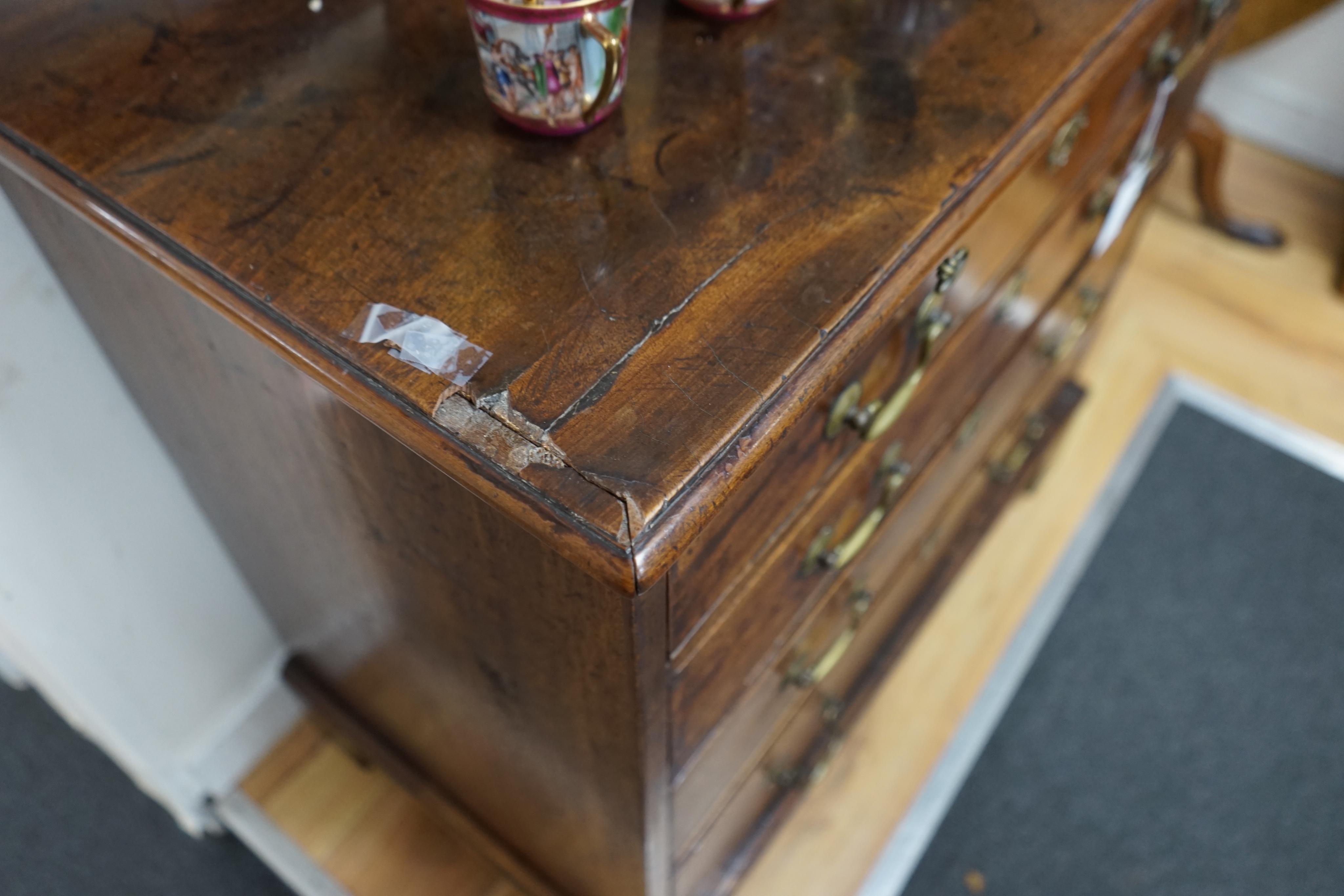 A George III mahogany chest of four graduating long drawers with brushing slide and brass handles, width 85cm depth 49cm height 84cm